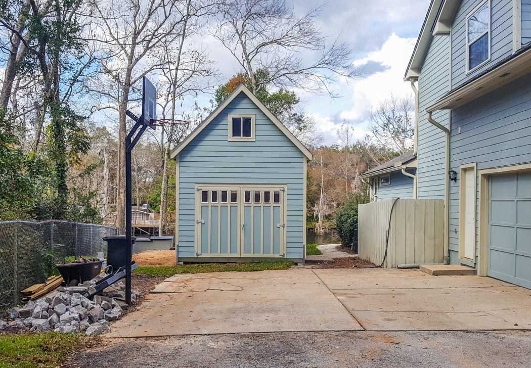 Big and Tall blue Tuff Shed building with basketball hoop