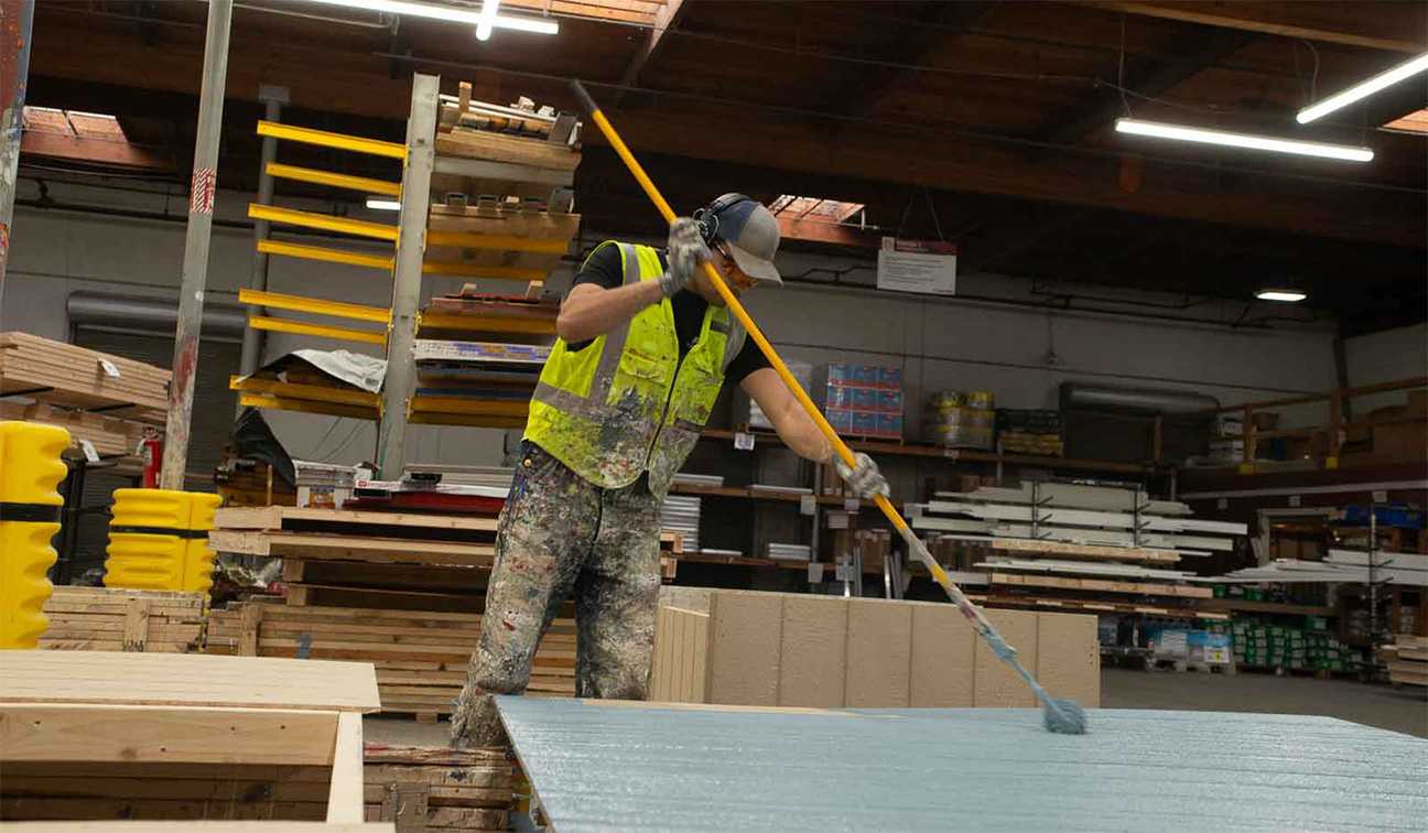 Tuff Shed employee painting a wall