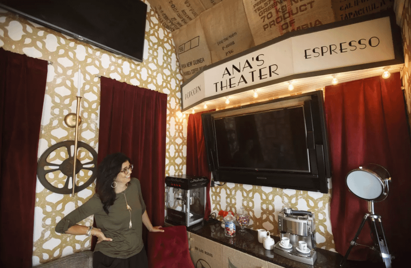 Interior of Premier PRO Tall Barn Weekender Theater with coffee making products on a bar and a woman looking at them