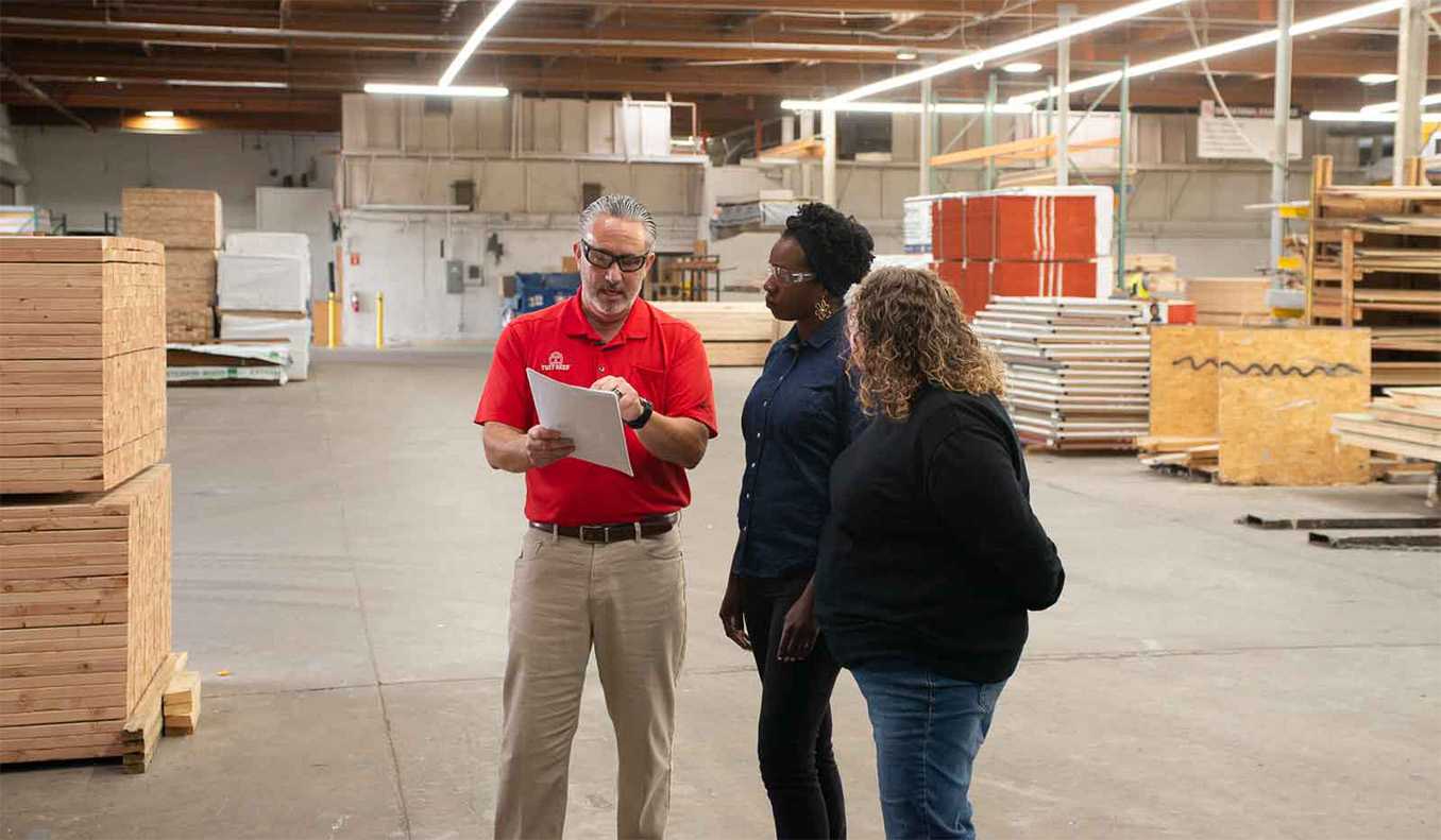 Tuff Shed sales manager discusses building plans with customers