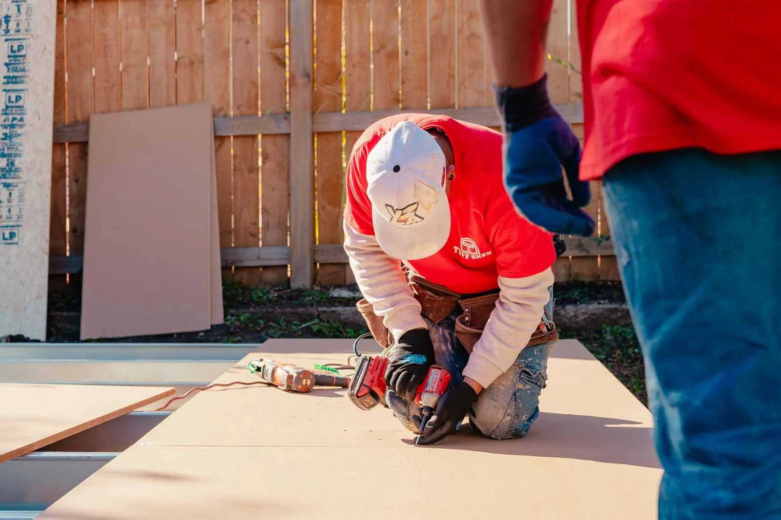Premier Tall Barn installers working on floor