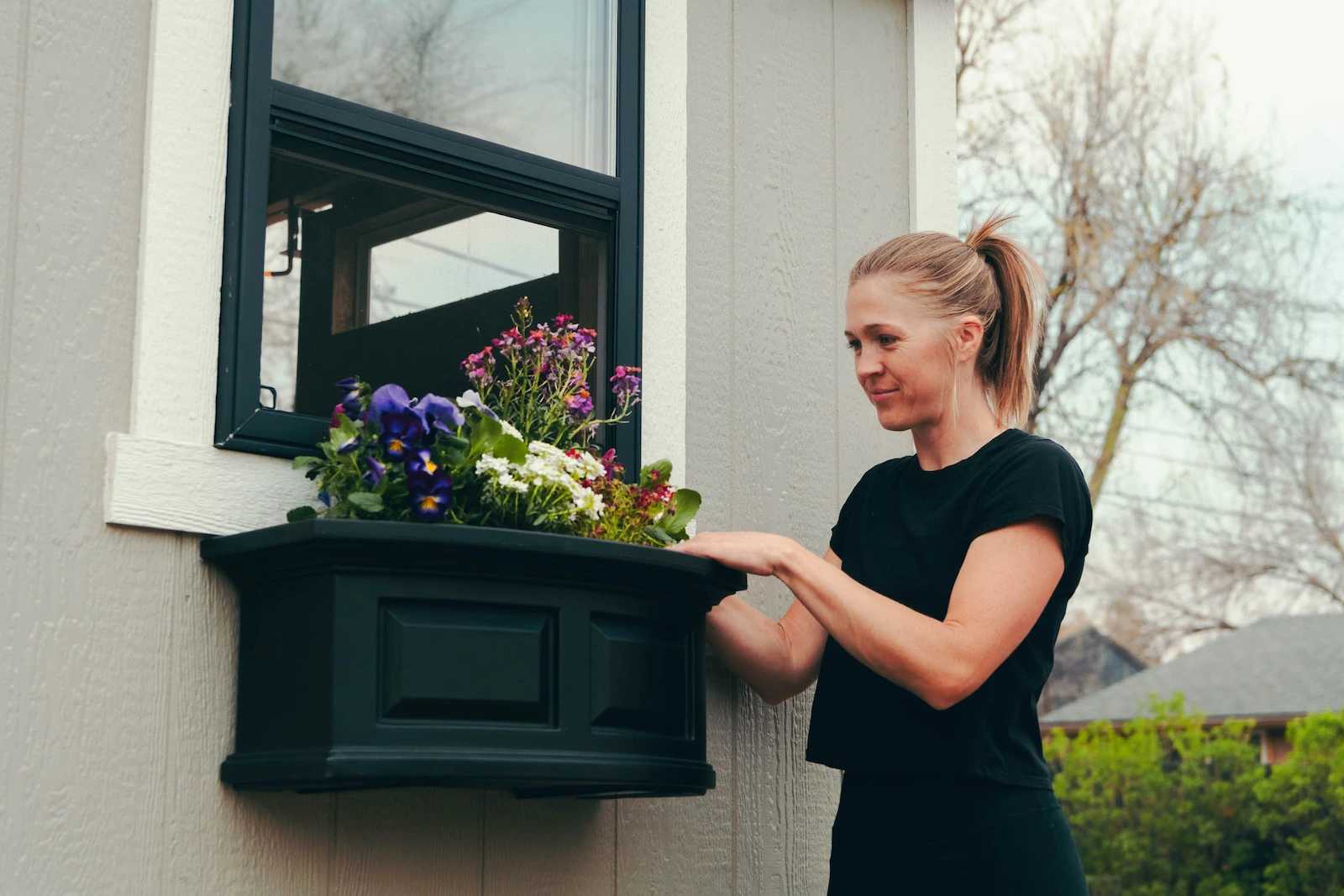 Karen planting flower boxes on her Premier Tall Barn