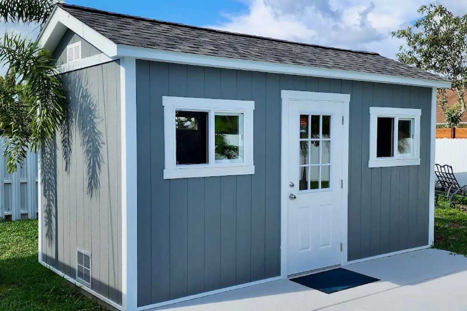 Tall blue building with residential doors and sliding windows
