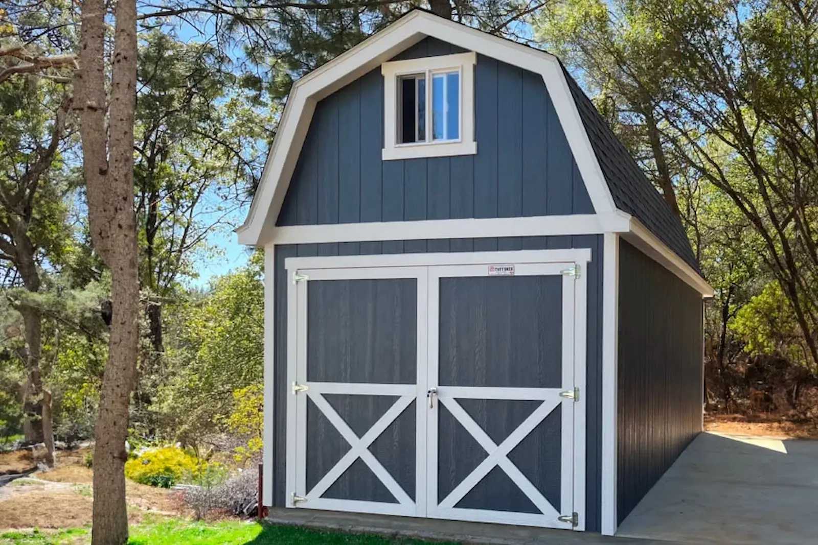 Blue tall barn with double door and window in gable