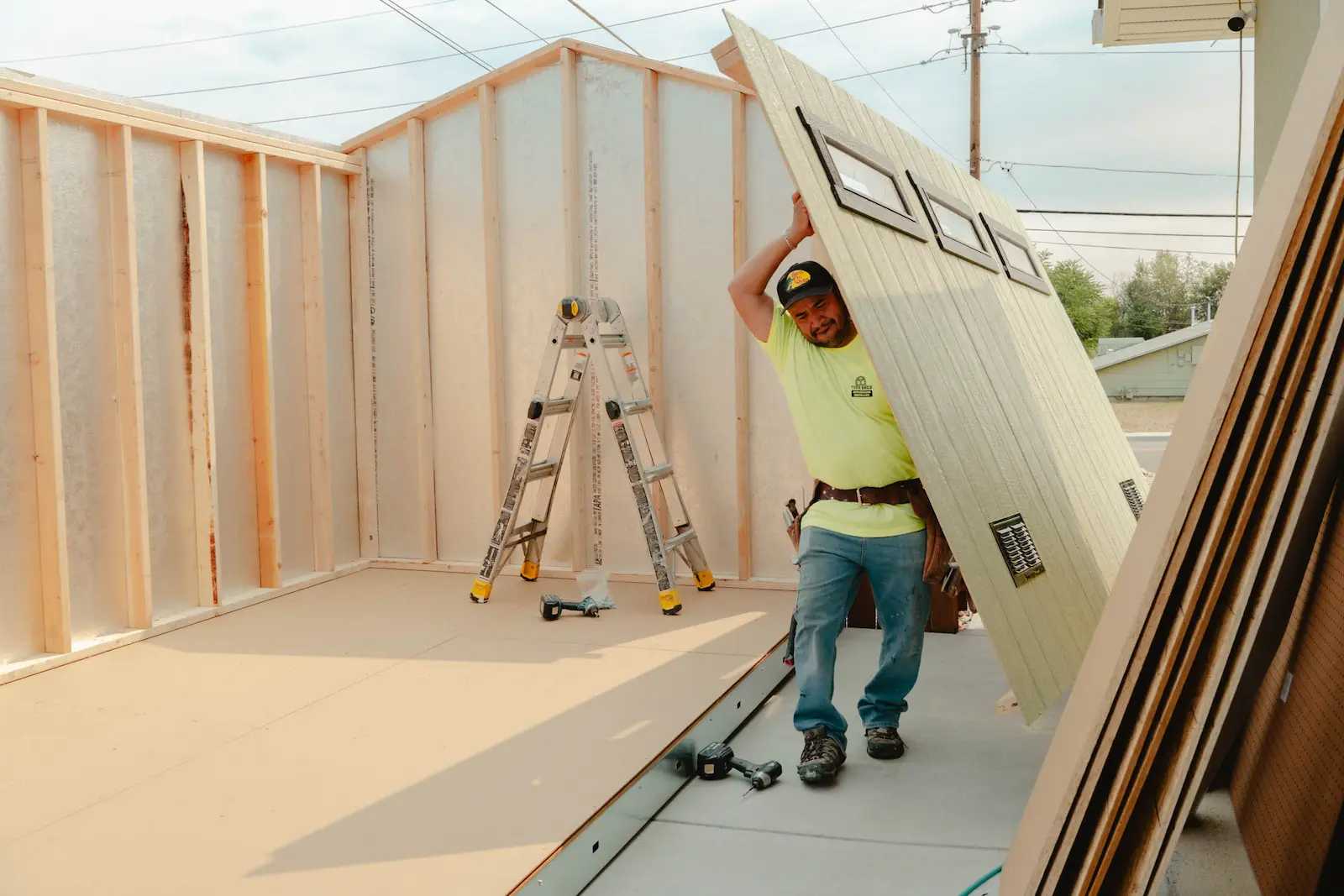 Premier Classic Ranch being installed and one installer carrying a wall