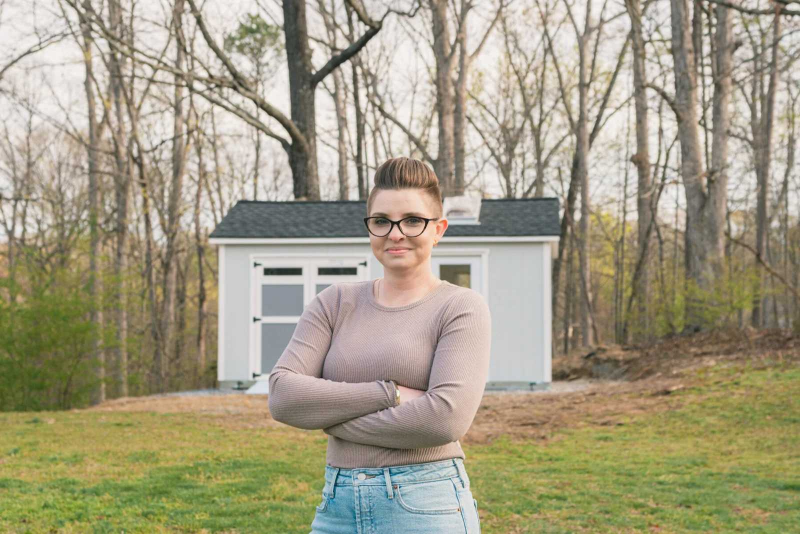 Lela standing in front of her Tuff Shed