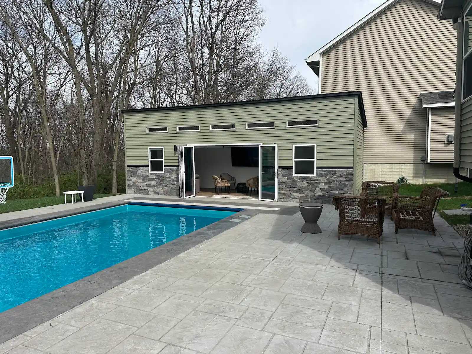 Green Premier Lean To pool shed with a brick front and windows