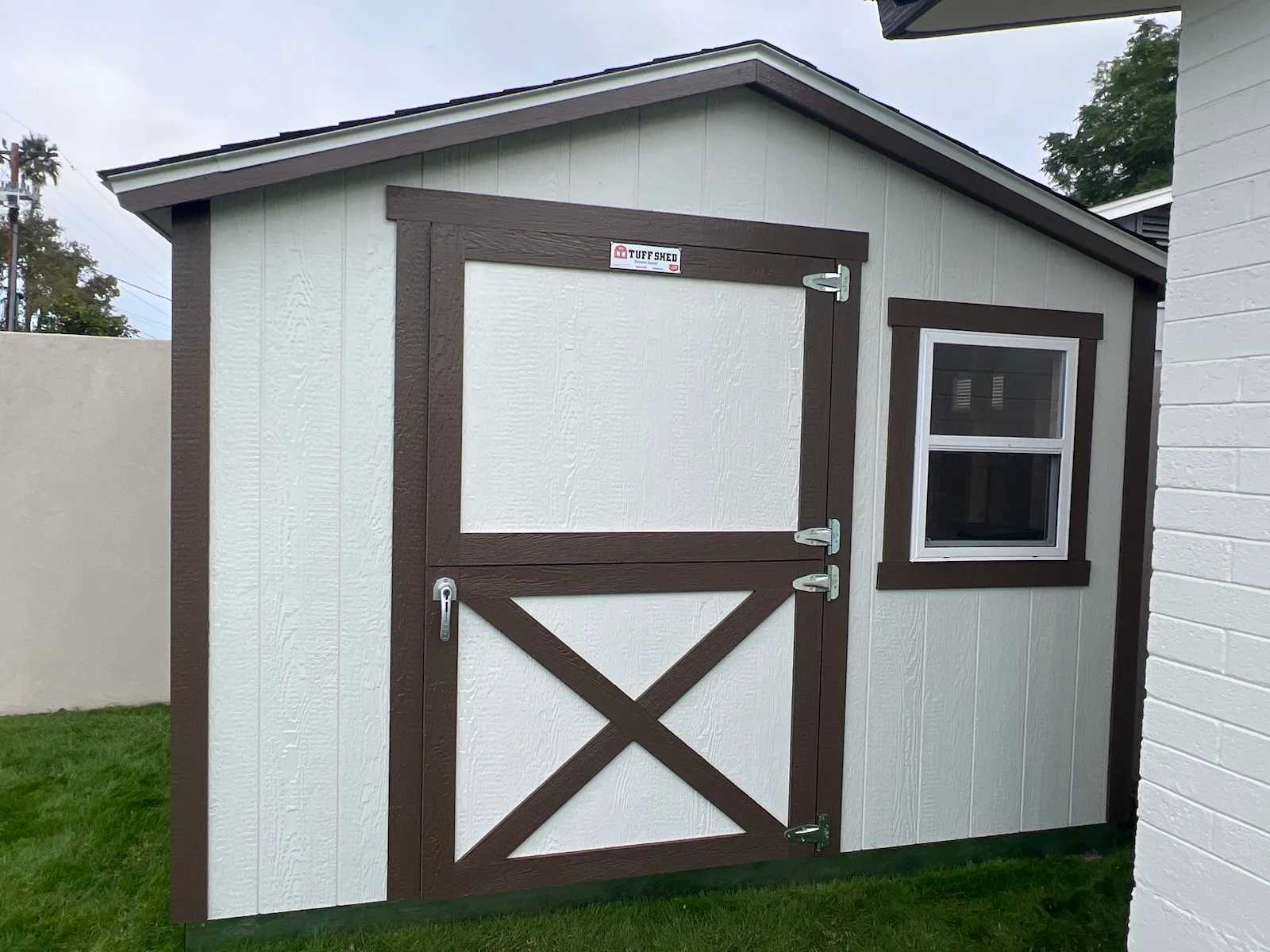 White Premier Standard Ranch building with brown trim and a window