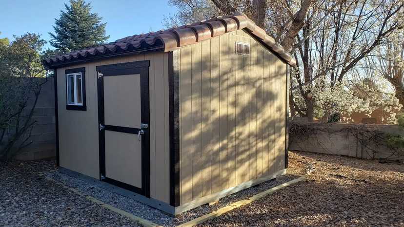 Tan Premier Classic Ranch with a tiled roof in a backyard w
