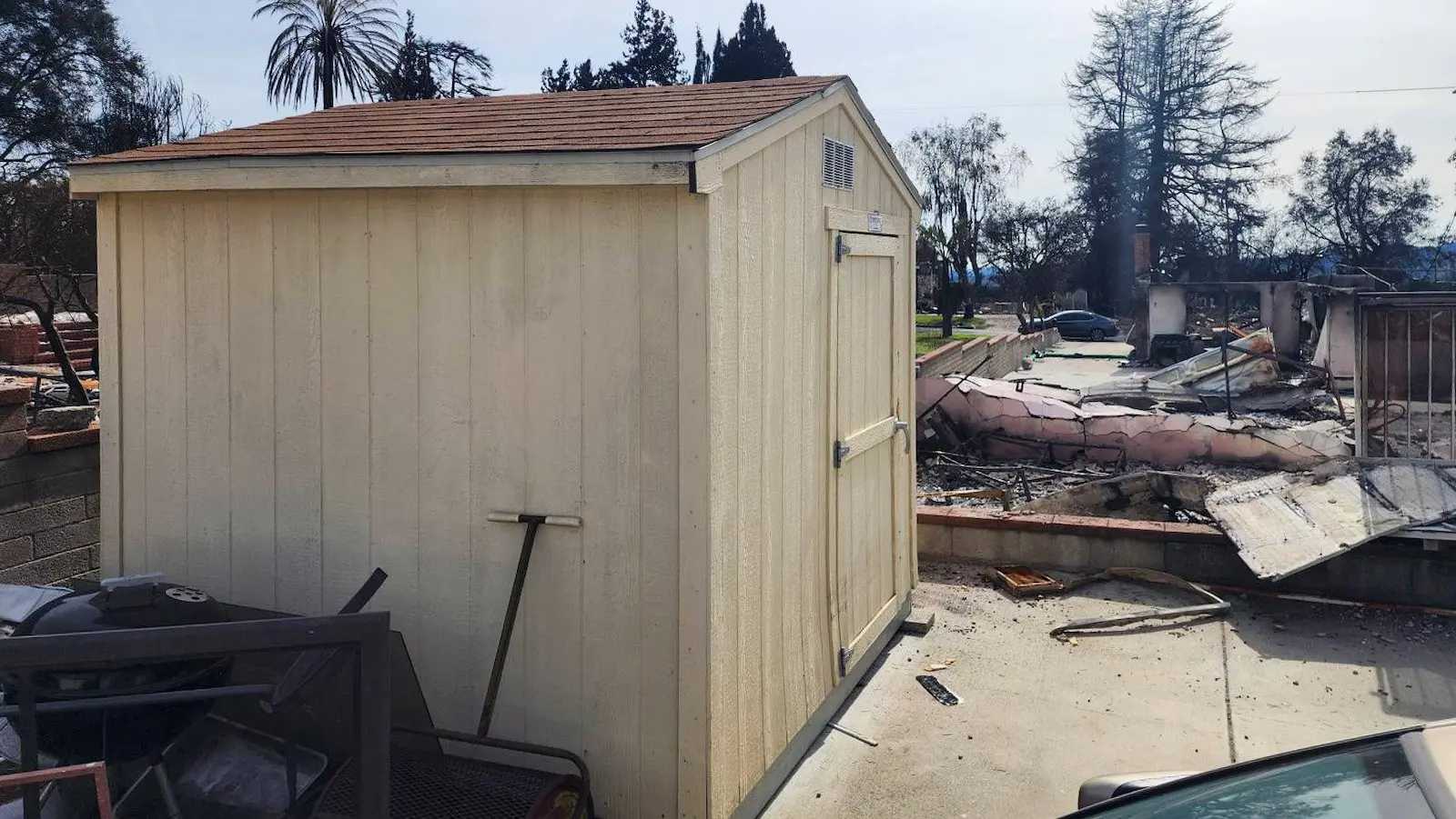 Tan Premier Ranch shed standing next to a destroyed lot
