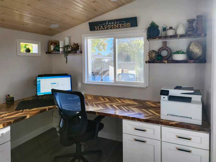 A premier pro studio home office with chair and a PC.