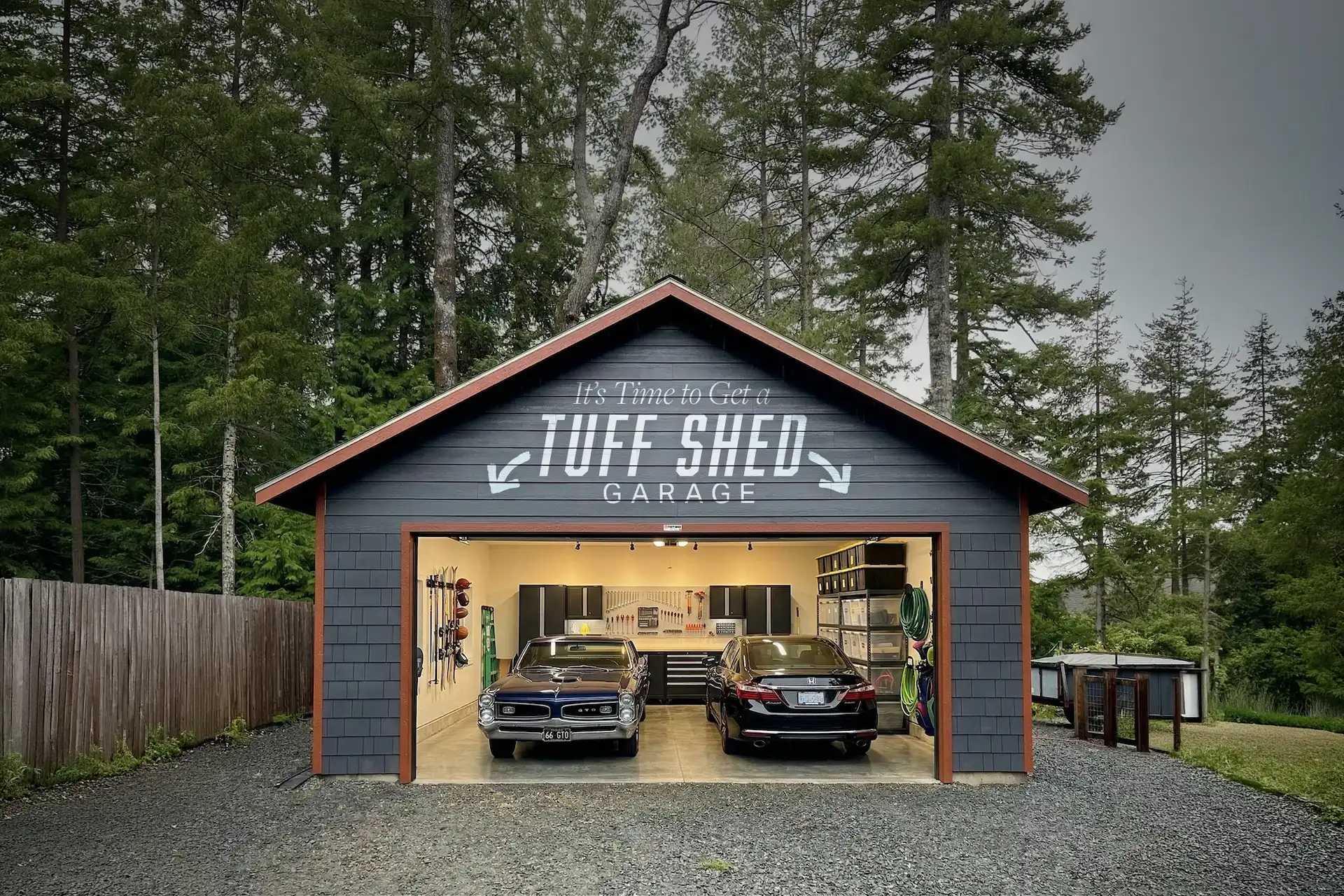 Dark Tuff Shed garage with open door and two cars inside