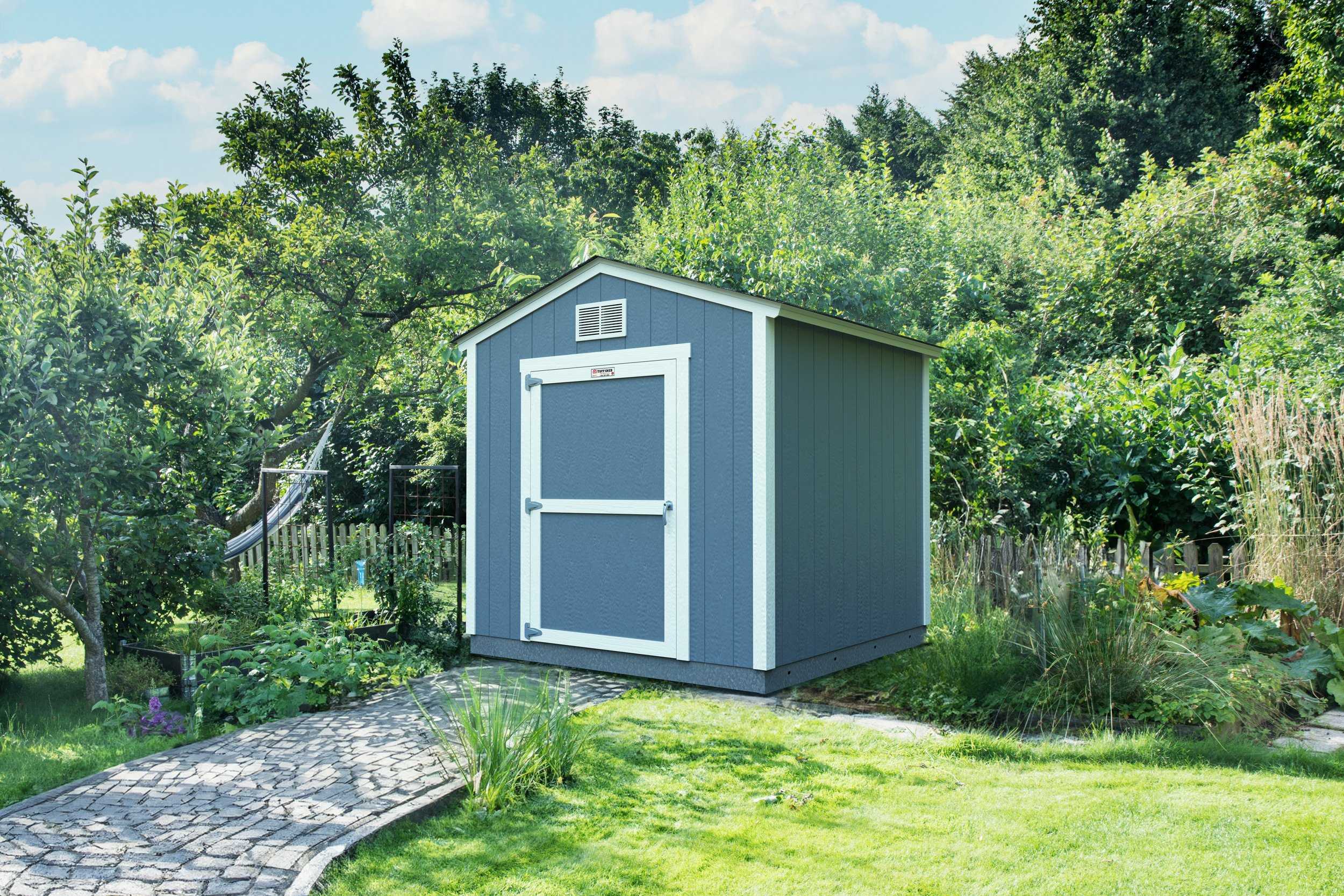 Blue and white shed that is in a residential backyard