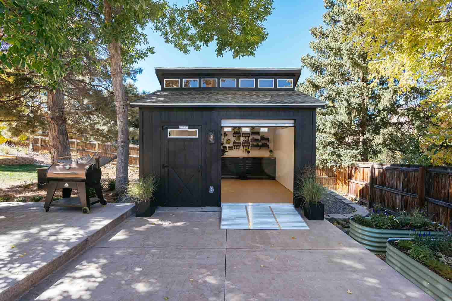 black tuff shed clerestory ranch building with rollup door and heavy duty ramps