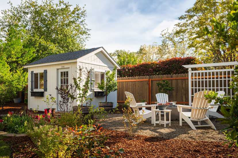 This is a premier pro ranch with a fire pit and chairs off to the side.