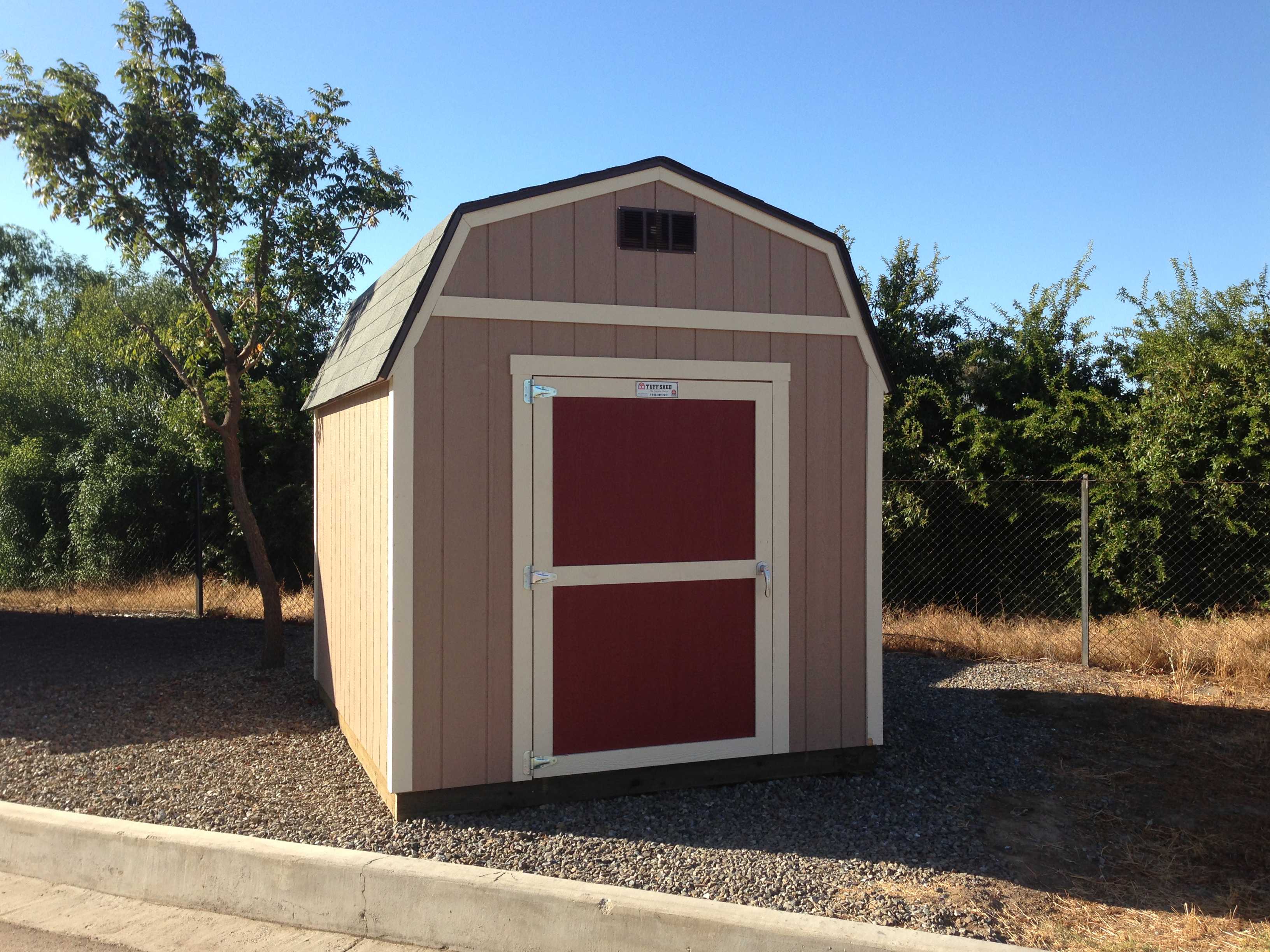 A garden barn for storage for gardening tools.