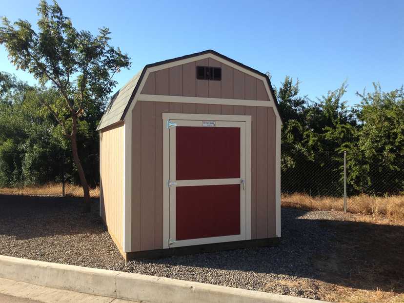 A garden barn for storage for gardening tools.