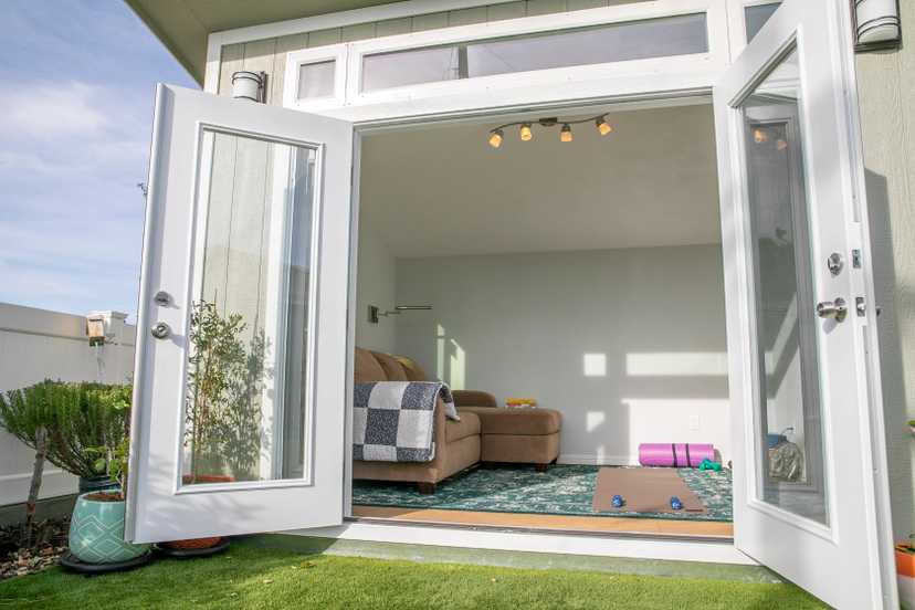 Premier pro studio with a couch and stretching studio for a gym in a shed.