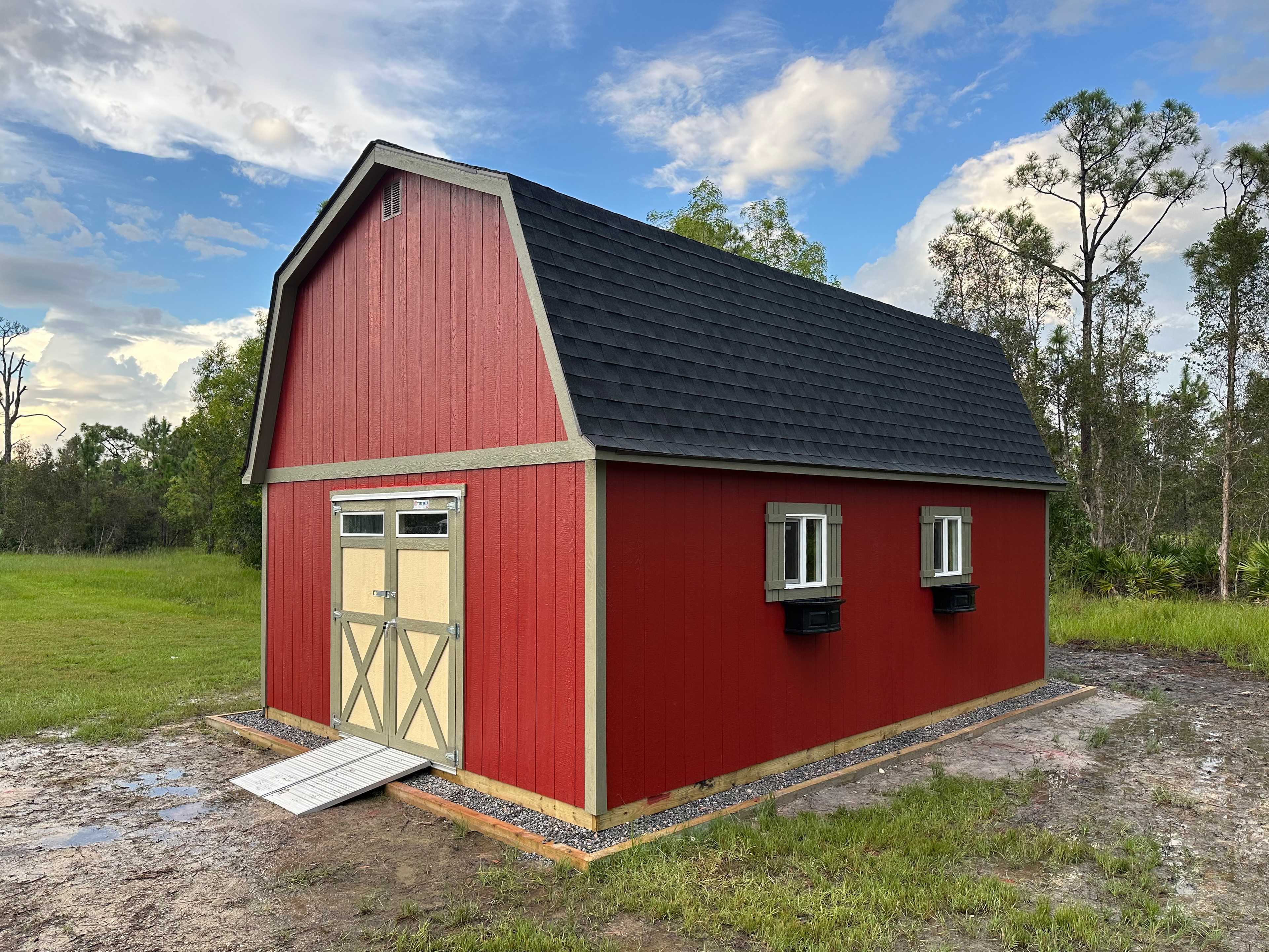 A Premier pro tall barn in the backyard of a large country house.