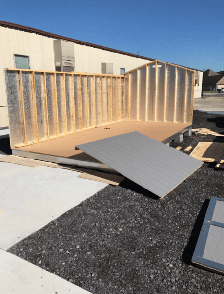 Exterior of South Side Elementary Shed Prize being installed back and side wall up