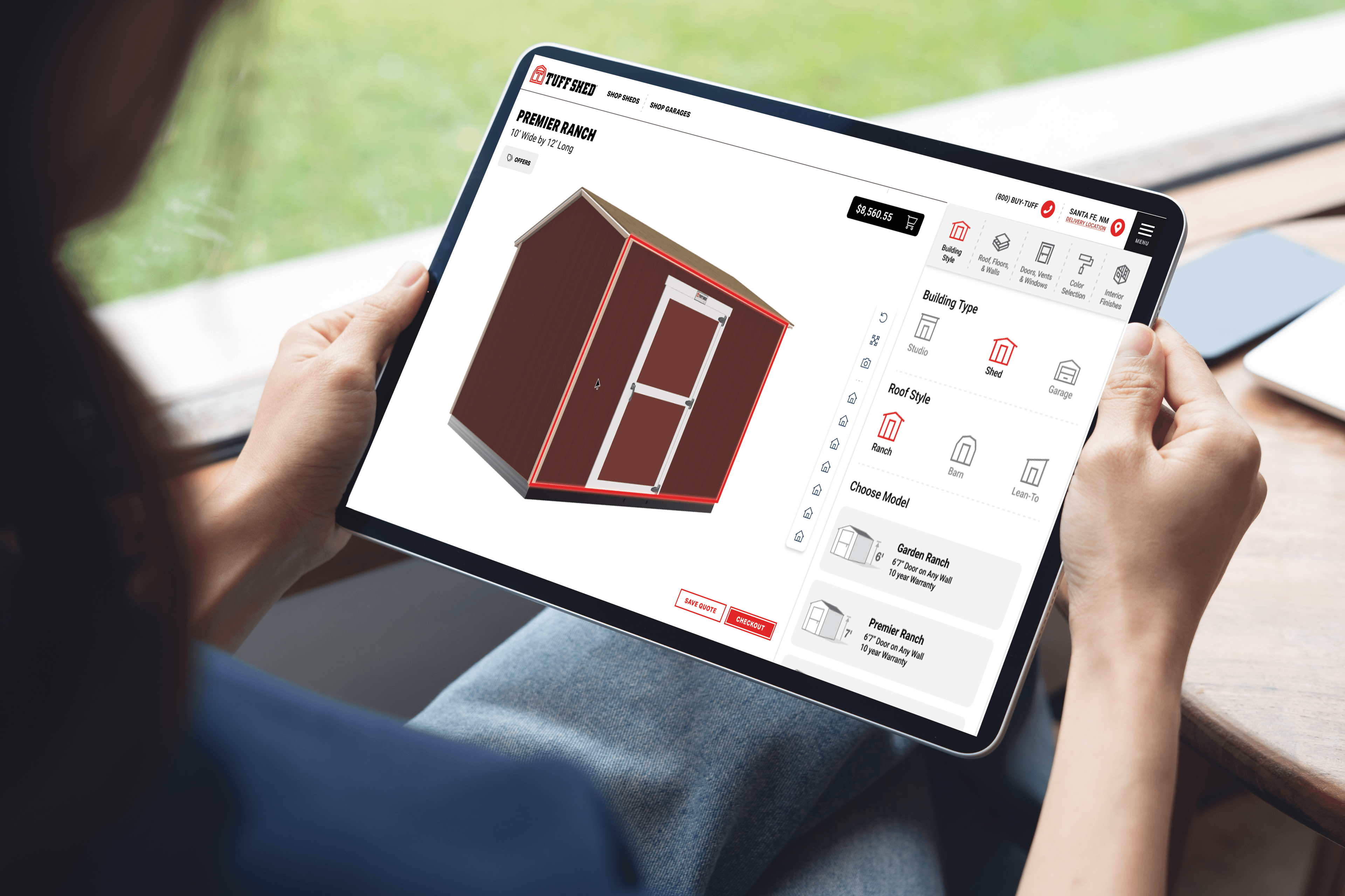 A woman holding designing a shed on the ipad