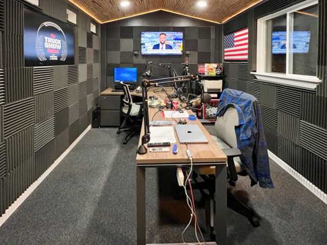 A premier tall ranch with office supplies like computers and a desk