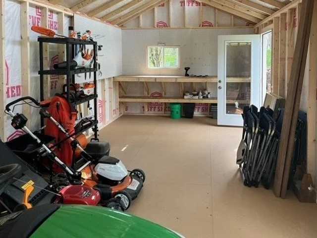 A picture of the inside of a shed with the storage of lawn tools