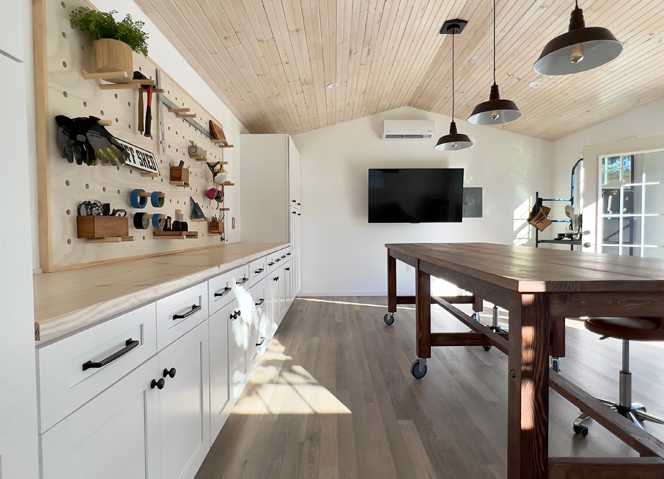Interior of Premier Pro Ranch Garage workshop with DIY pegboard and workbench