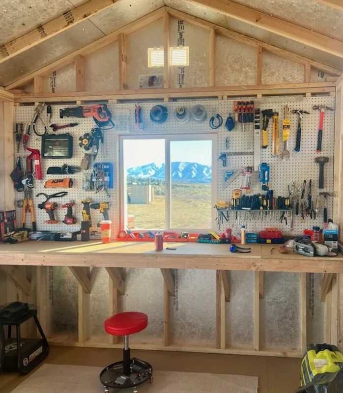 The interior of a shed with tools hung on the wall inside of a Tuff Shed