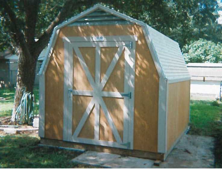 Yellow and white harden barn for backyard storage.