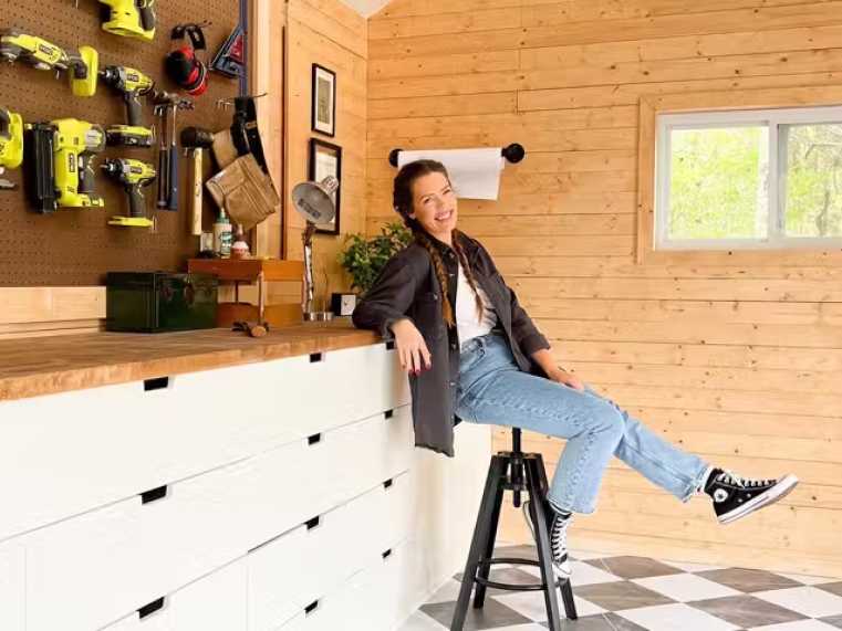 stylish workshop shed with organized pegboard of tools and custom workbench