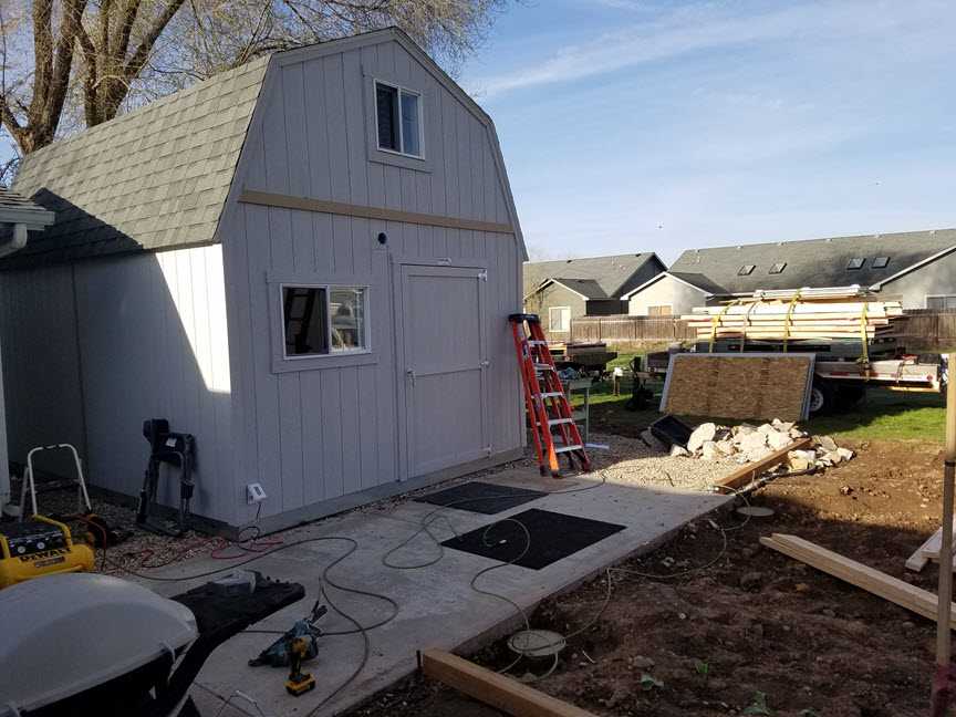 The shed in construction with a ladder and a lot of power tools around
